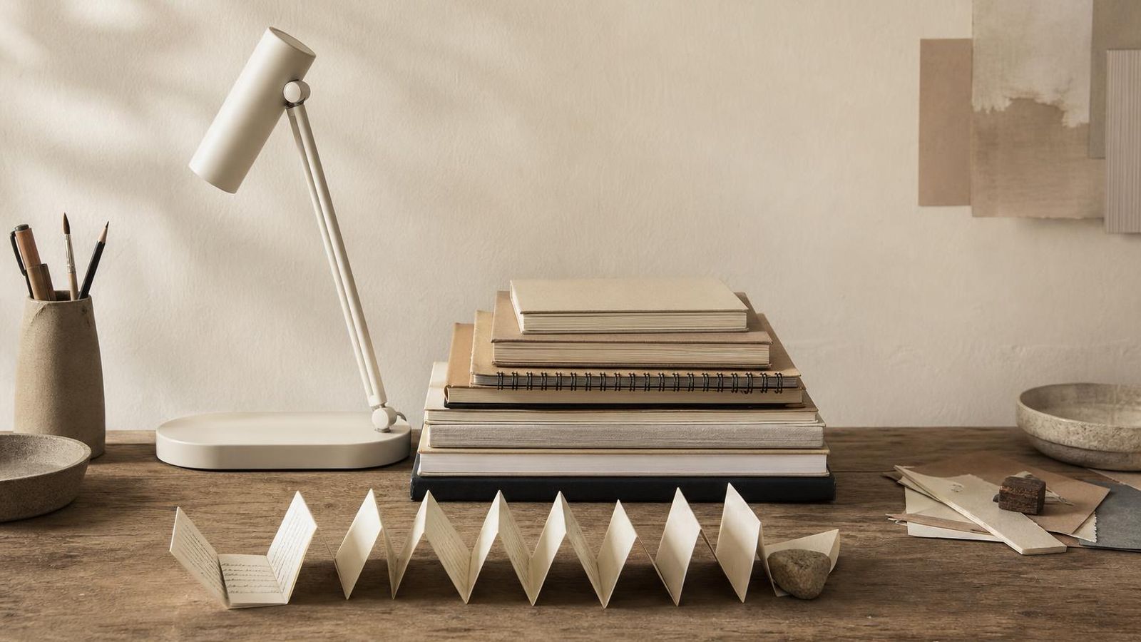 A quiet desk with stacked notebooks