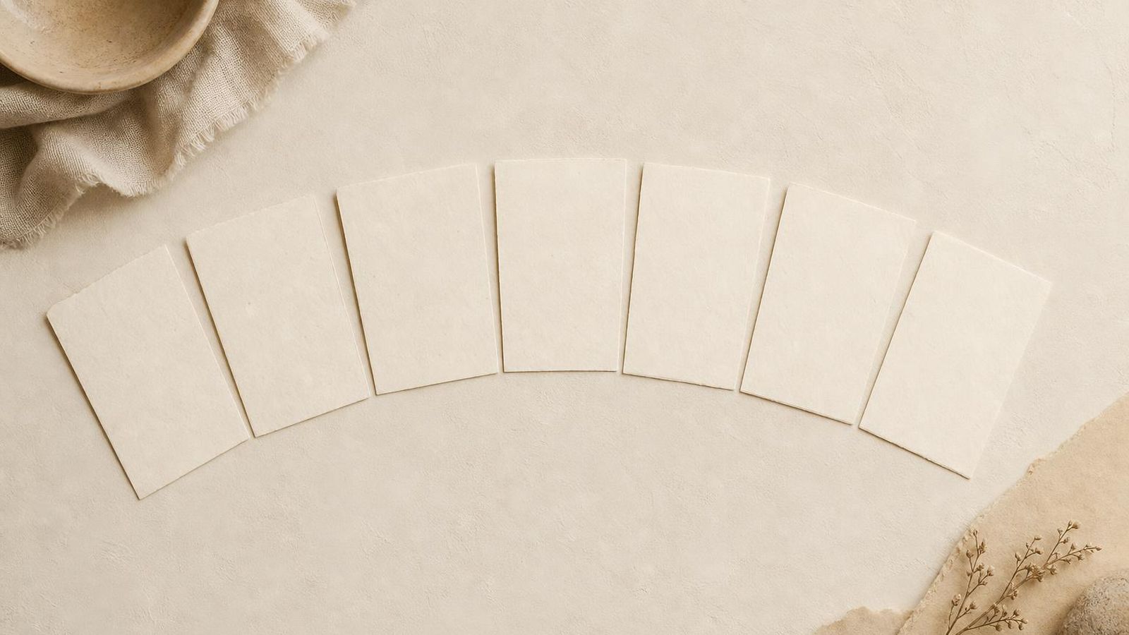 A row of seven small index cards laid in a calendar arc